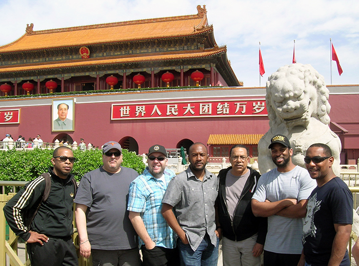 Members of Los Texmaniacs and Tremé Brass Band strike a pose in front of Mao Zedong’s portrait and a stone lion in Beijing’s Forbidden City. Photo by James Deutsch